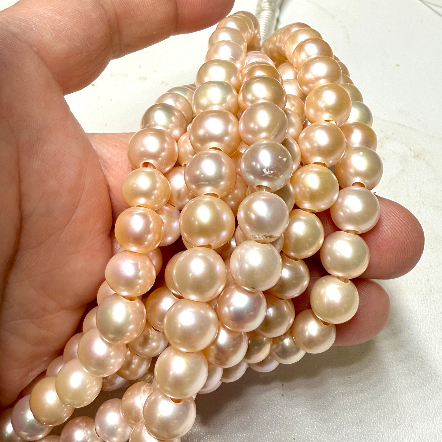 Round 8.5mm Blush color pearls with 2mm hole. 8" Strands