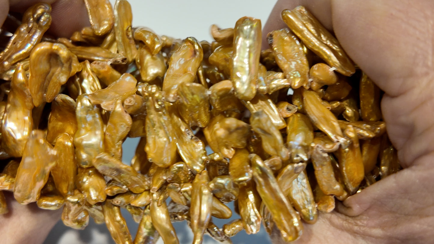Golden Head Drilled Stick Pearls.  Lots of luster.  approx 5x20 graduated.  $10 a strand!