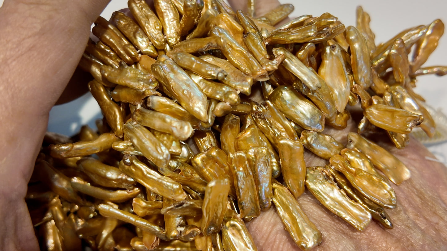 Golden Head Drilled Stick Pearls.  Lots of luster.  approx 5x20 graduated.  $10 a strand!