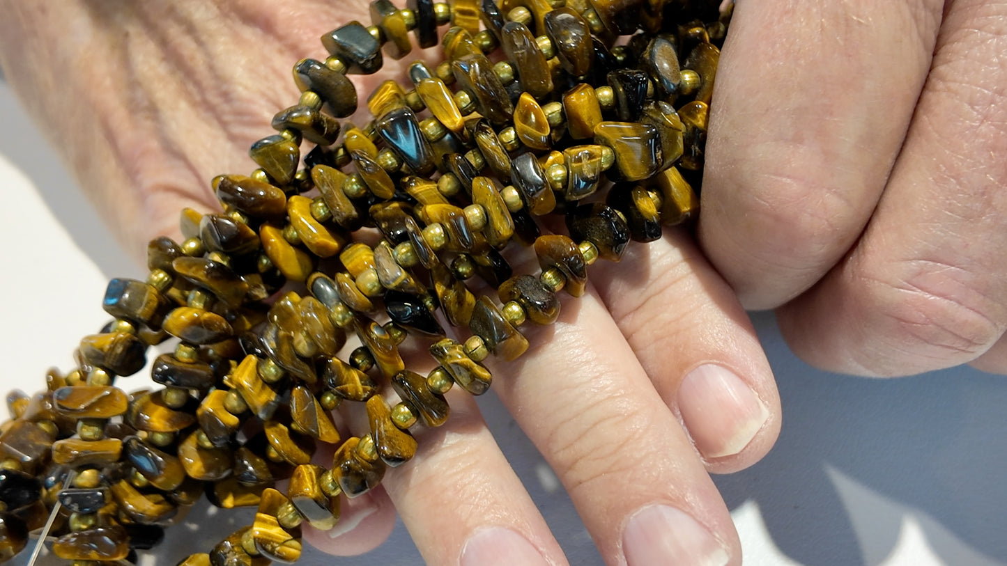Tiger Eye with metal beads. Polished nuggets 24" strands graduated $10 a strand