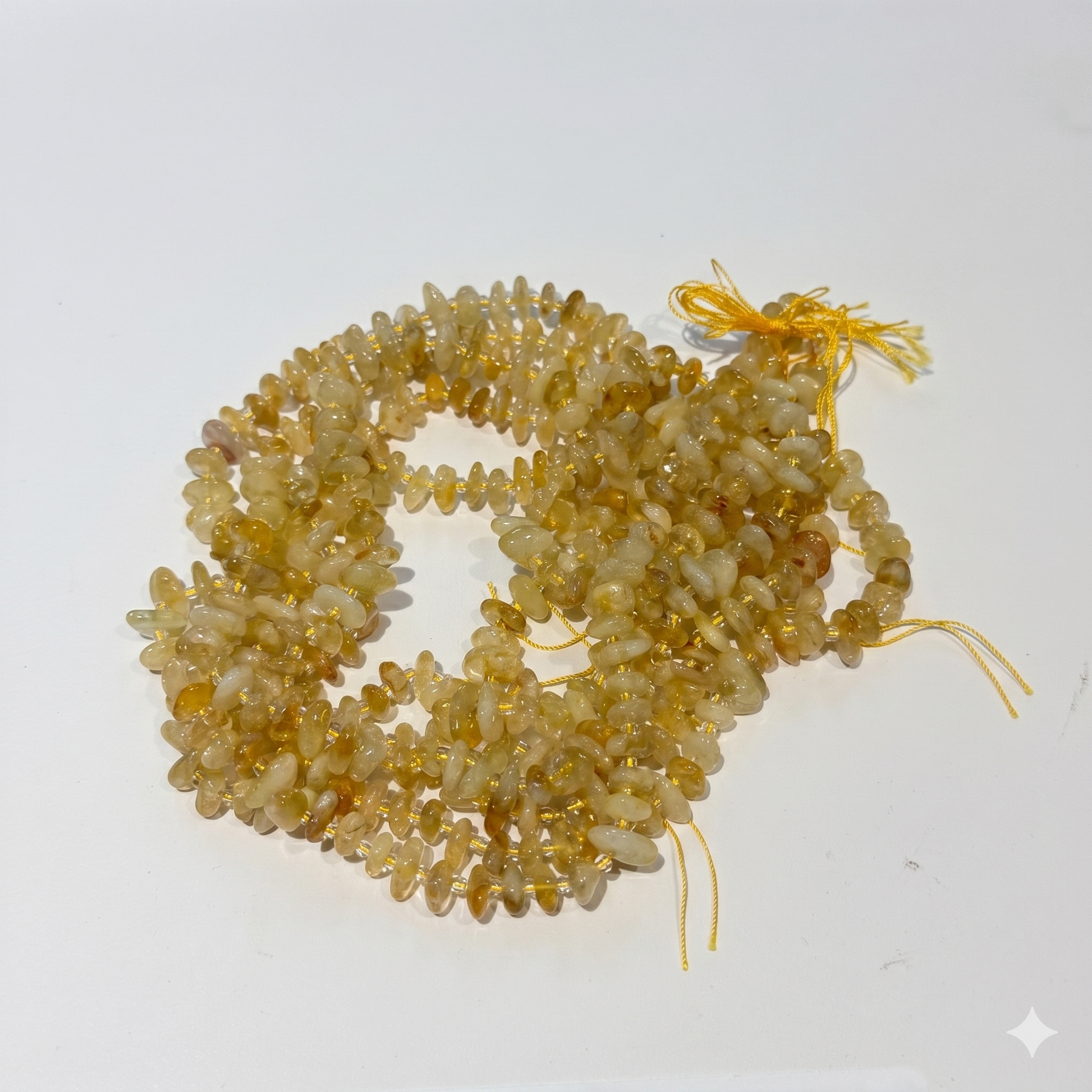 Necklace made of light brown beads on a white background