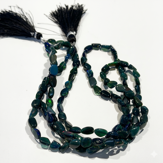 Black Ethiopian Opal Beads.  Green and blue flashes of intense color.  15" strands