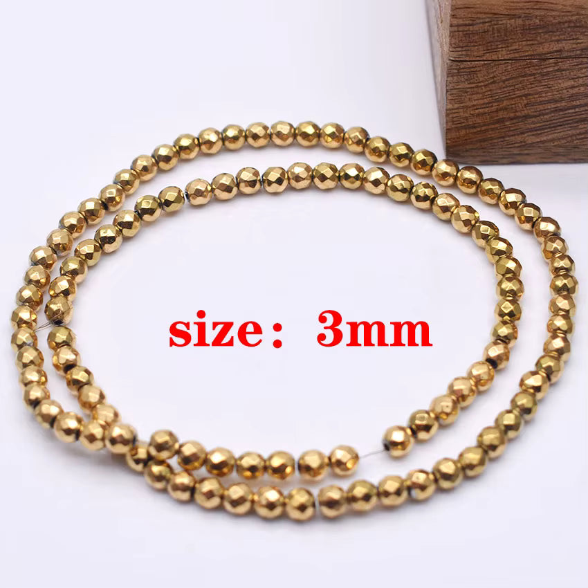 A strand of faceted gold beads, each bead measuring 3mm, coiled on a white background with a wooden block in the corner and red text reading 'size: 3mm'.