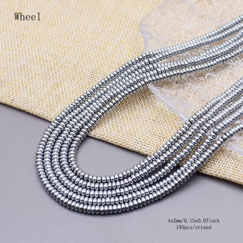 Five strands of silver hematite beads arranged in a loop on a gray surface with a beige woven fabric backdrop. Text in the top left reads 'wheel', and text in the bottom right specifies 4x2mm/0.