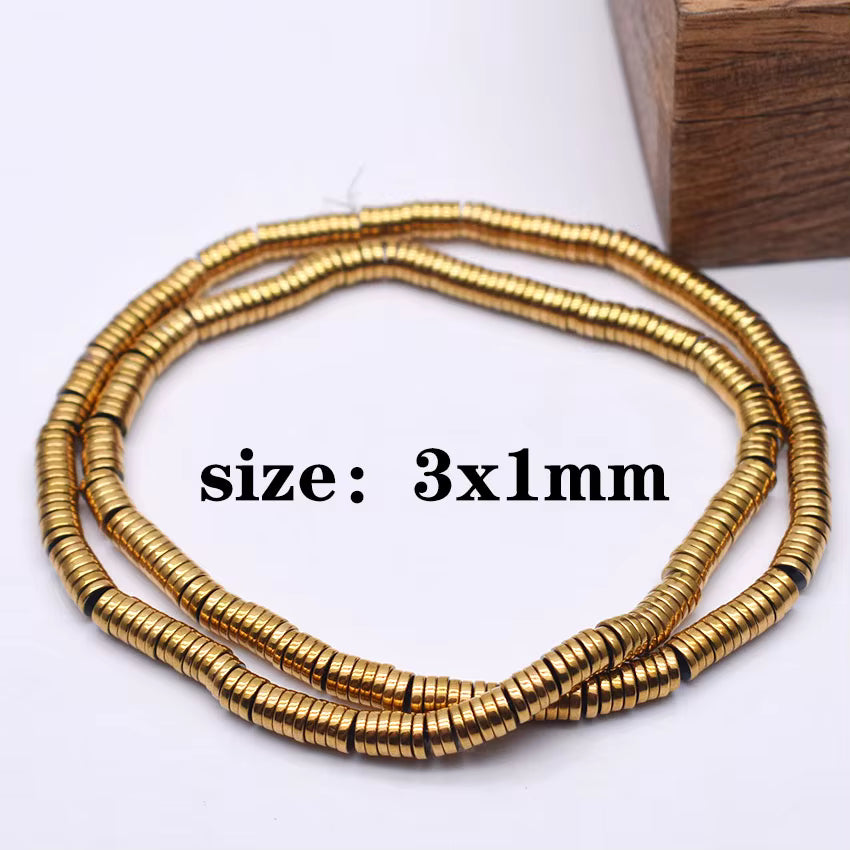 Three coiled strands of small metallic gold disc beads, with black spacer beads occasionally visible, displayed on a white background with a wooden block in the corner and the text 'size: 3x1mm' overlaid in the center.