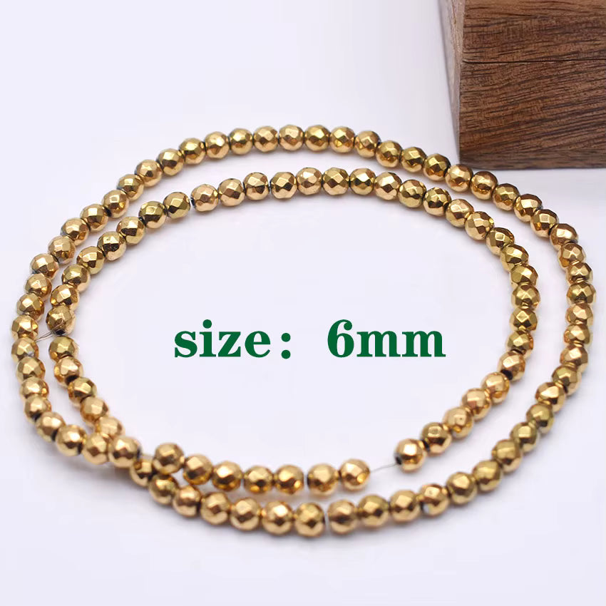 A strand of faceted gold beads, each bead measuring 6mm, coiled on a white background with a wooden block in the corner and 'size: 6mm' text overlay.