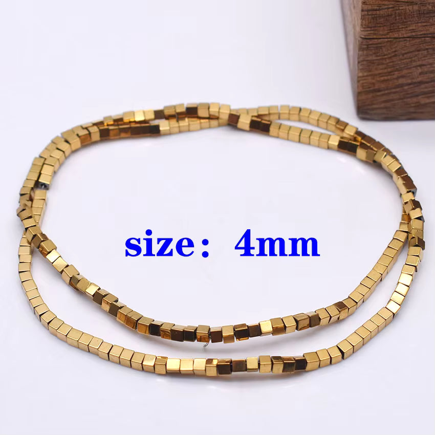 A coiled strand of small metallic gold cube-shaped beads on a white background, with blue text reading 'size: 4mm' overlaid in the center.