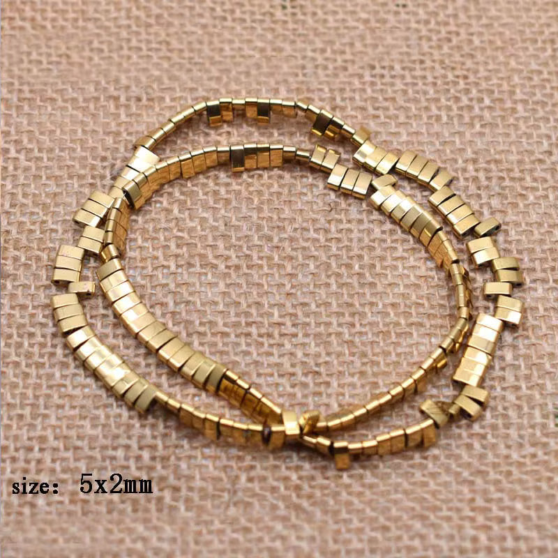 Gold metallic rectangle beads arranged in two loops on a beige woven fabric background, with text in the lower left reading 'size: 5x2mm'.