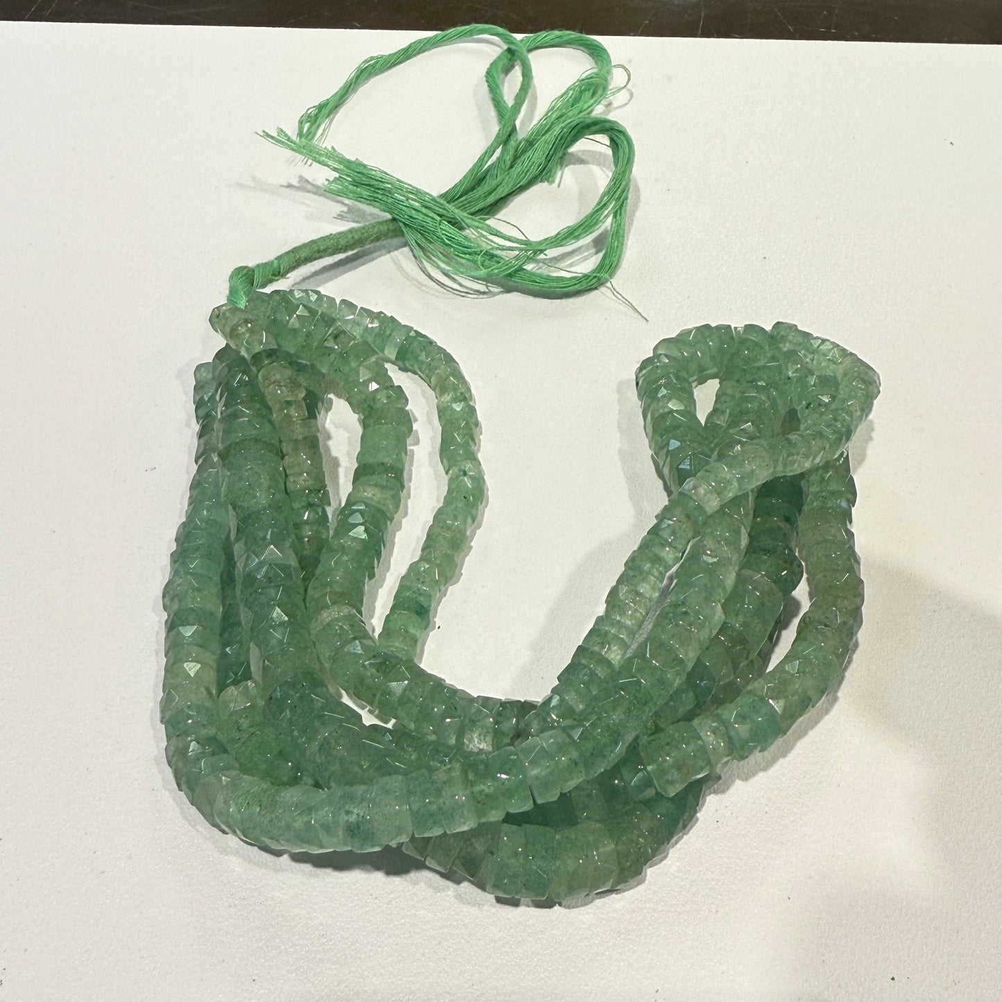 Green Aventurine Natural."Tire Shape" faceted beads 16" long