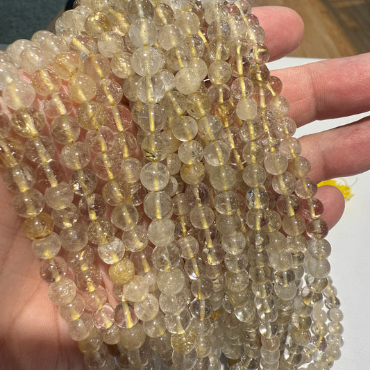 Rutilated Quartz.  Round approx 6 mm, 15" strands,  Nice gold color