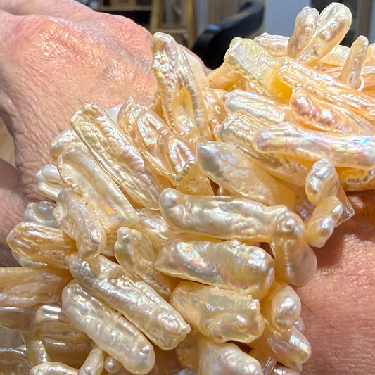 Japanese Biwa Pearls from the 80's.  Center drilled 15" strands, cream color