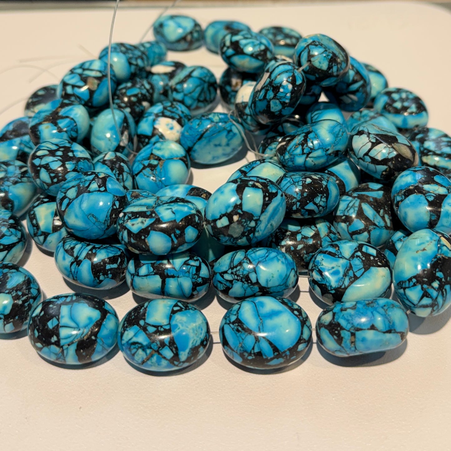 Magnesite, treated to make it look really cool!  20x22mm 15" strands