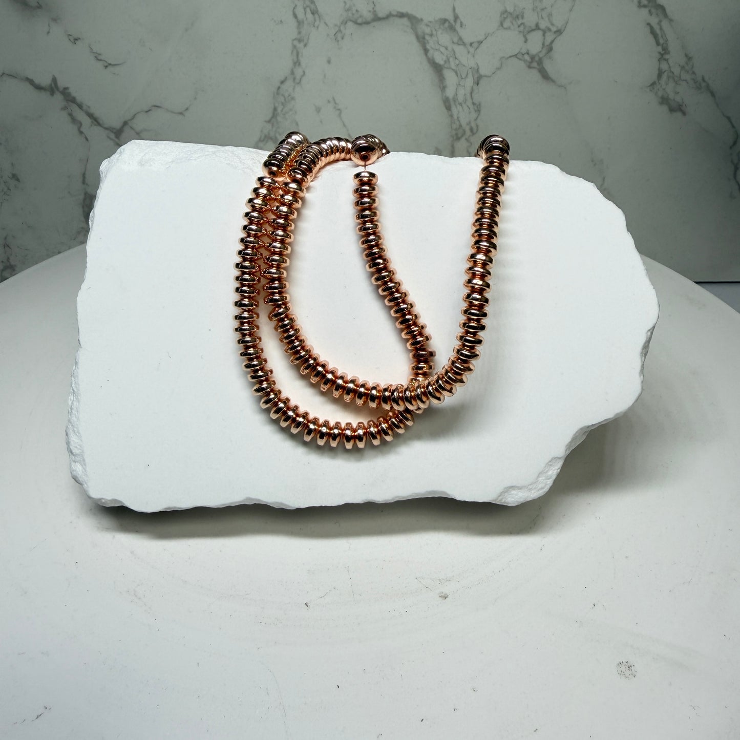 Hematite with Rose Gold PVD Finish.  Approx 15" Strands