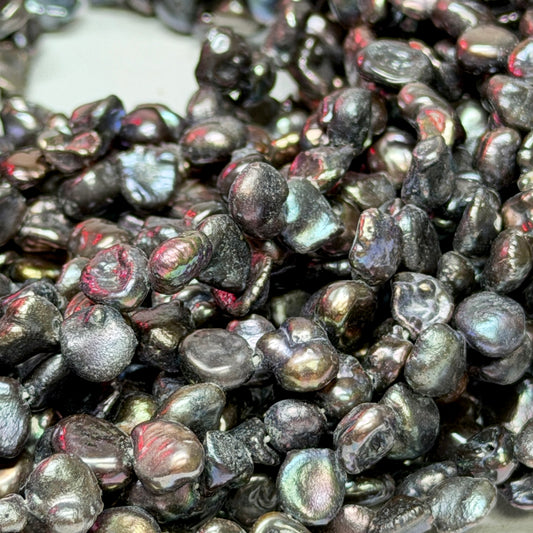 Closeup of Keshi pearls that are peacock in color