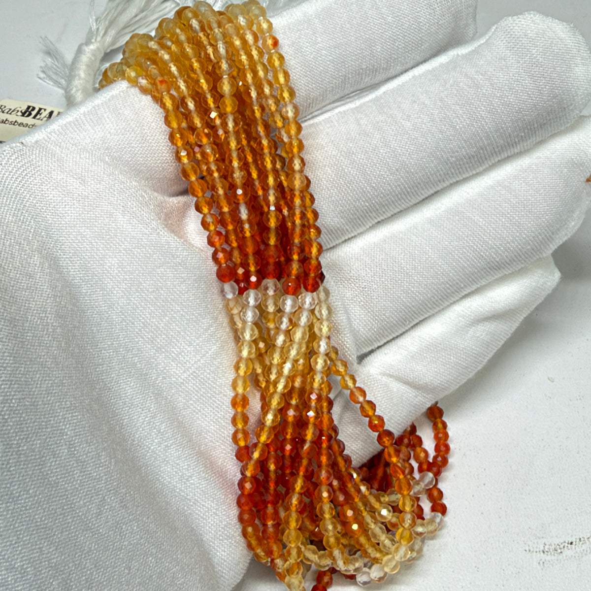 Natural Fire Opal from Mexico.  3mm faceted round beads approx 15" long