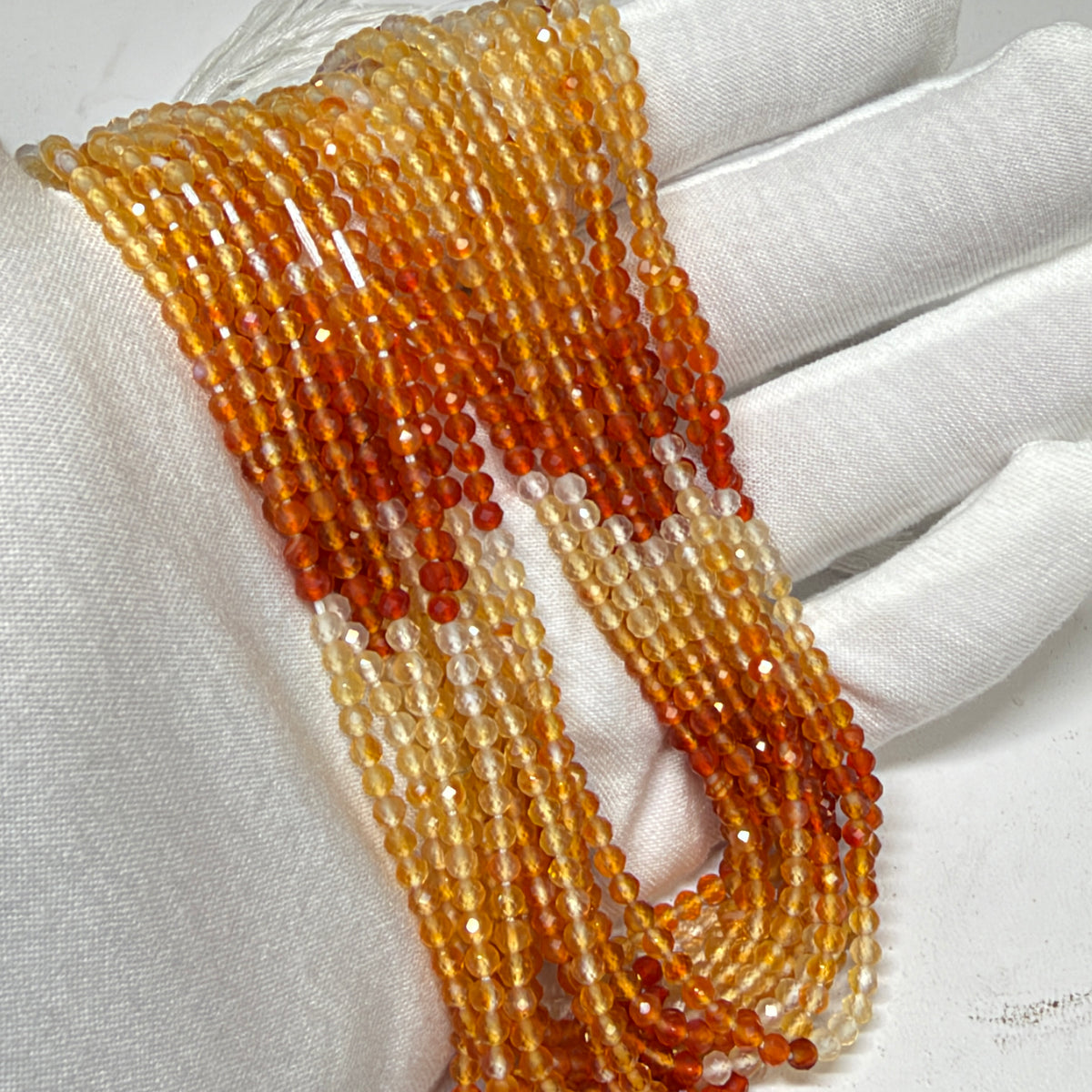 Natural Fire Opal from Mexico.  3mm faceted round beads approx 15" long