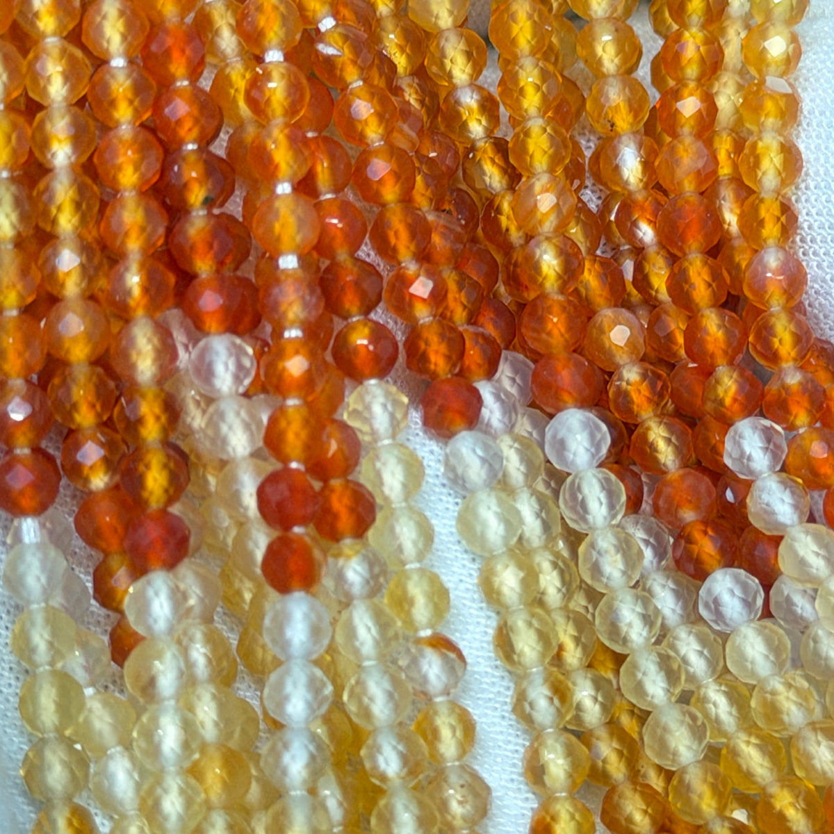 Natural Fire Opal from Mexico.  3mm faceted round beads approx 15" long