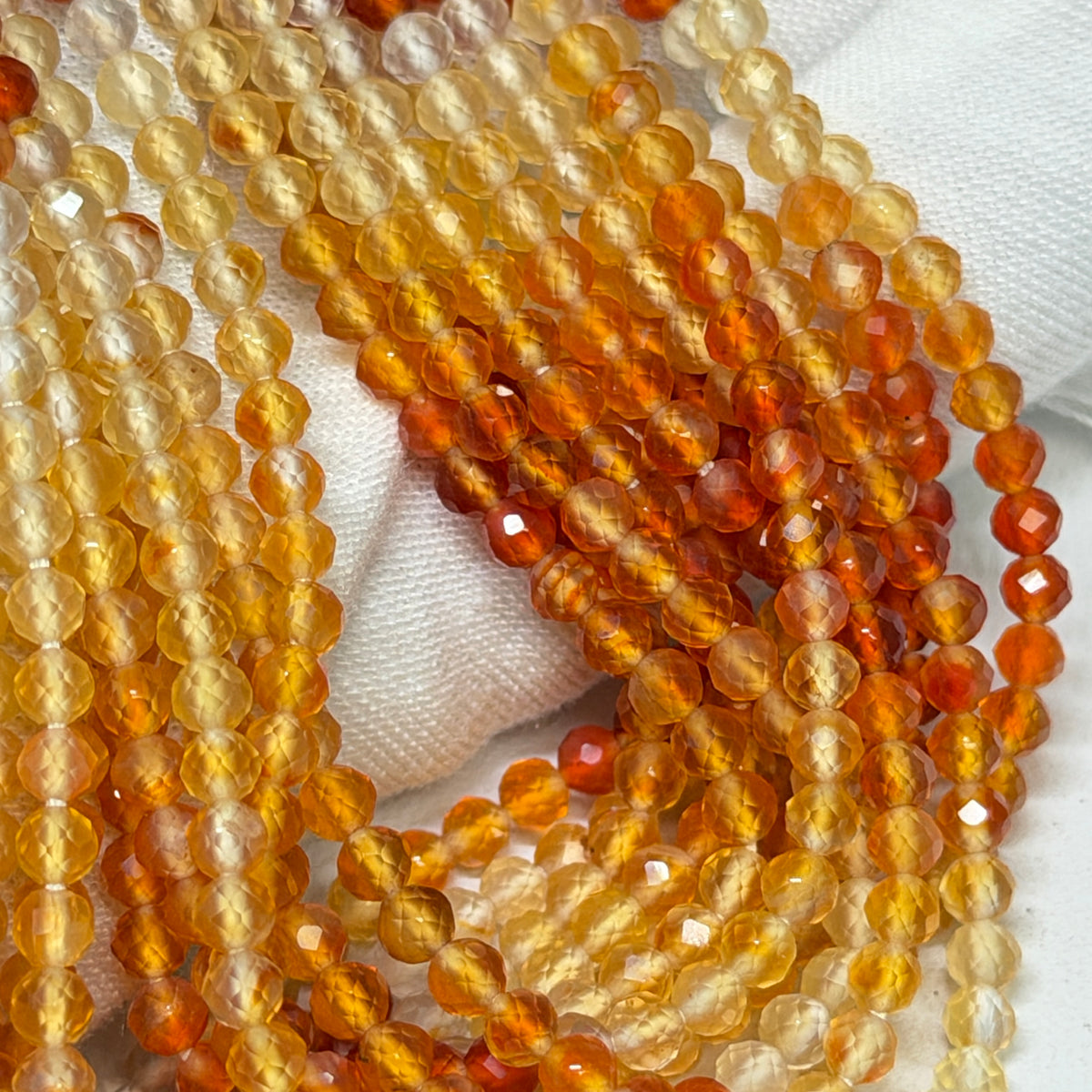 Natural Fire Opal from Mexico.  3mm faceted round beads approx 15" long
