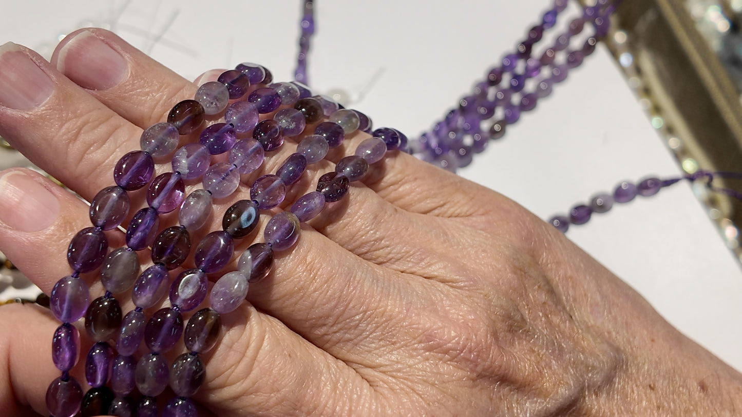 Natural gemstones 6x8mm approx 16" strands flat olive shape.  $10 a strand!