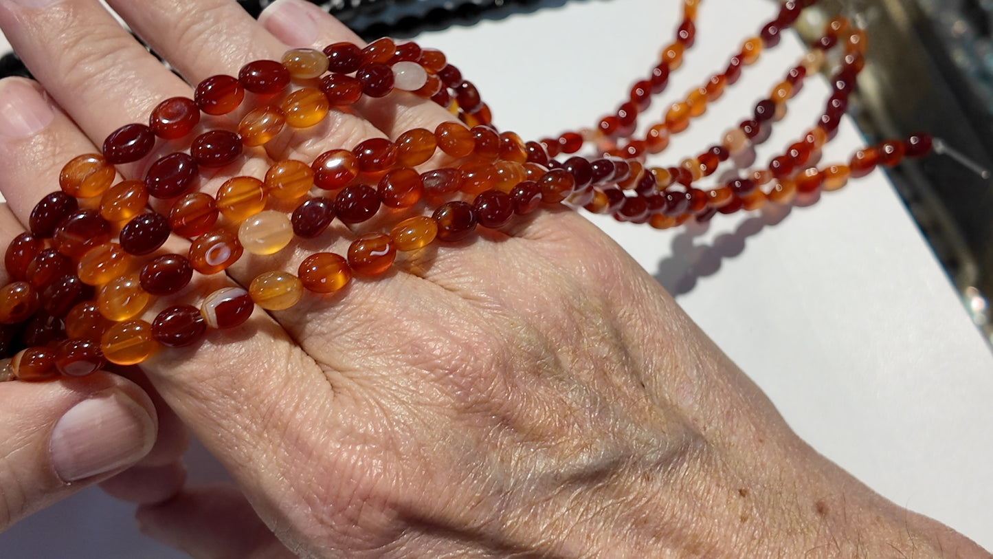 Natural gemstones 6x8mm approx 16" strands flat olive shape.  $10 a strand!