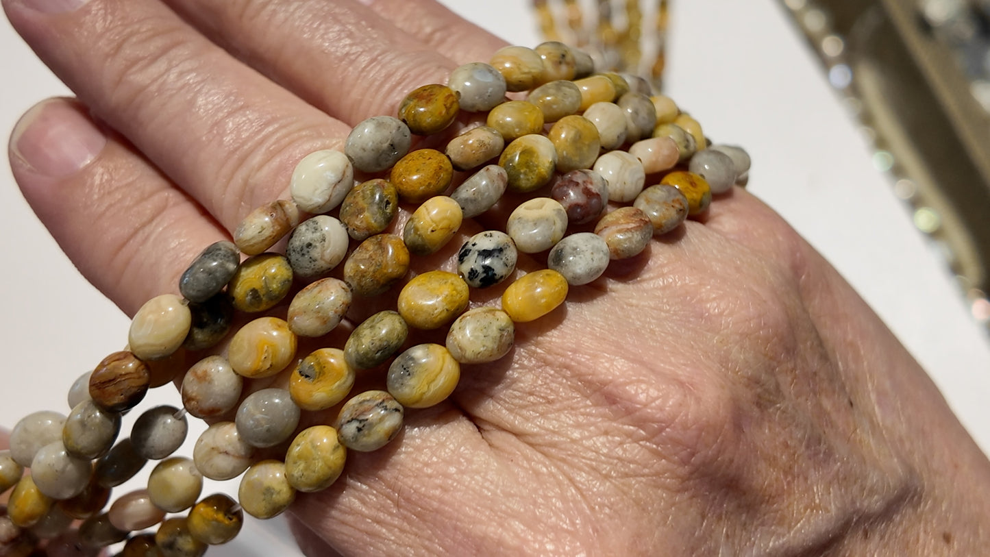 Natural gemstones 6x8mm approx 16" strands flat olive shape.  $10 a strand!