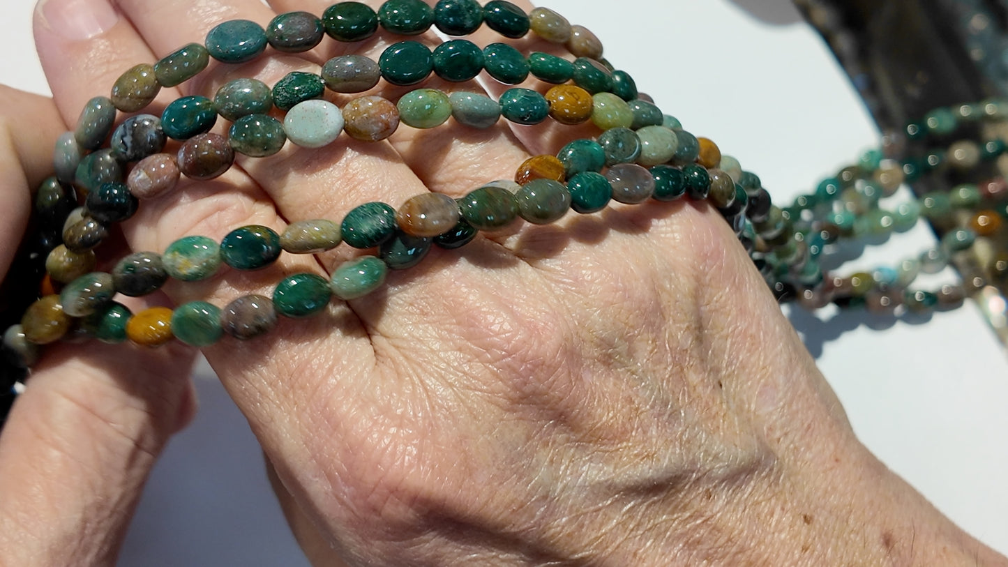 Natural gemstones 6x8mm approx 16" strands flat olive shape.  $10 a strand!