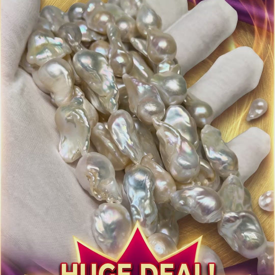 A vertical video thumbnail advertisement with a dramatic gold and purple background. A large, gloved hand holds many strands of large, irregularly shaped, iridescent Baroque "Fire Ball" pearls. Text at the top reads "BAROQUE 'FIRE BALL' PEARLS" and specifications. A prominent red starburst graphic at the bottom features text: "HUGE DEAL!", "REGULAR PRICE: $240" (crossed out), and "SPECIAL PRICE: $85 / STRAND."