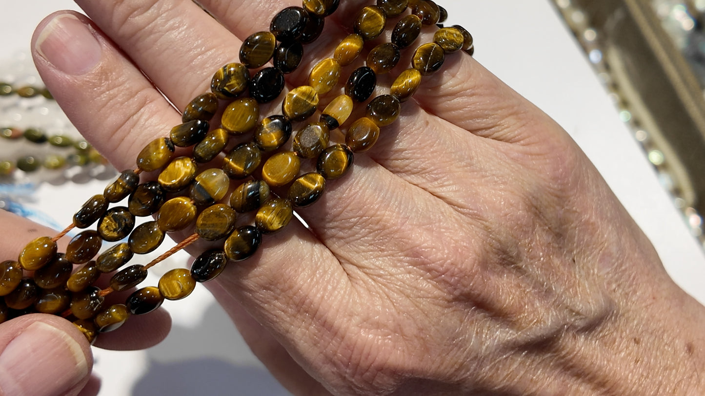 Natural gemstones 6x8mm approx 16" strands flat olive shape.  $10 a strand!